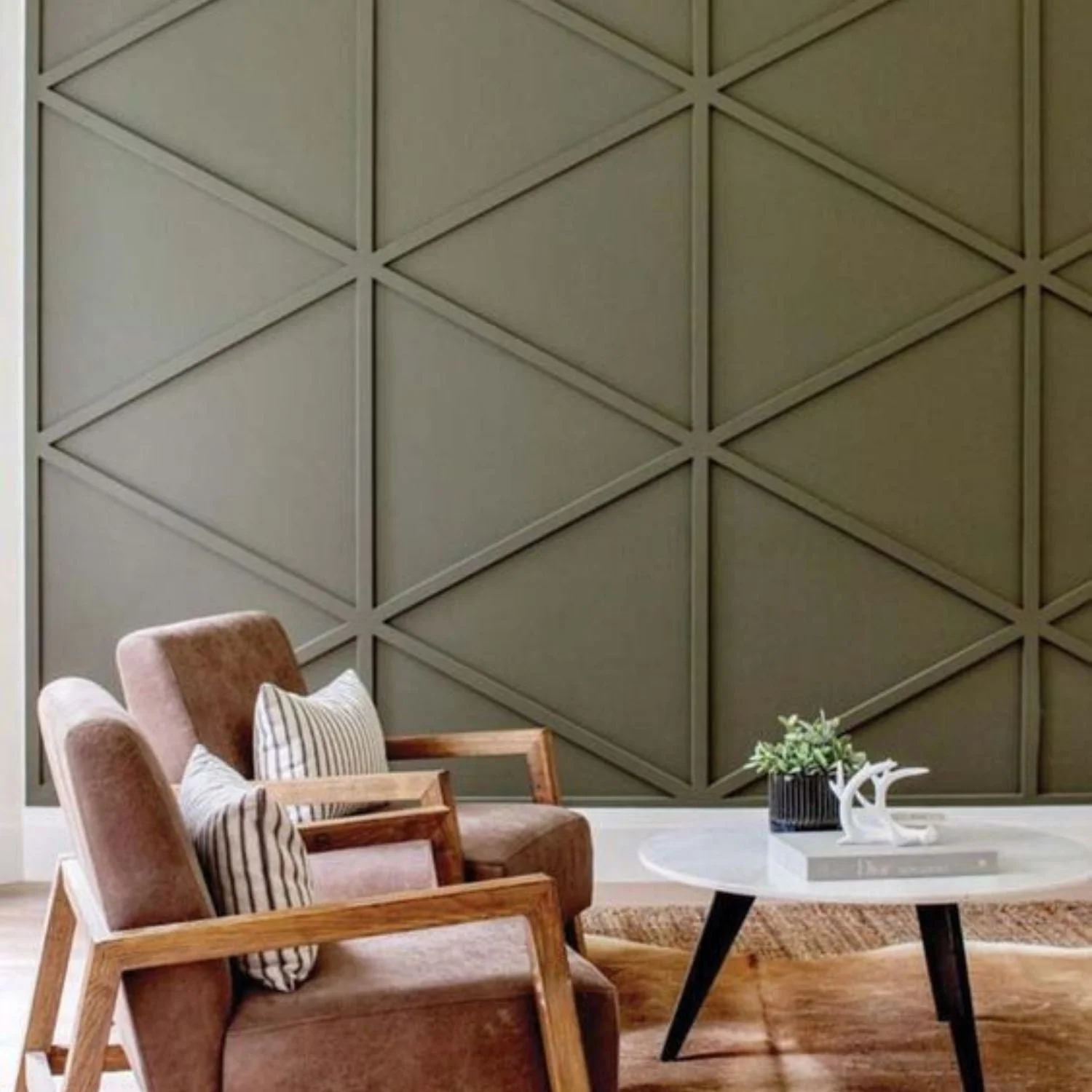 Artisan creating an intricate textured pattern on a feature wall with golden metallic finish